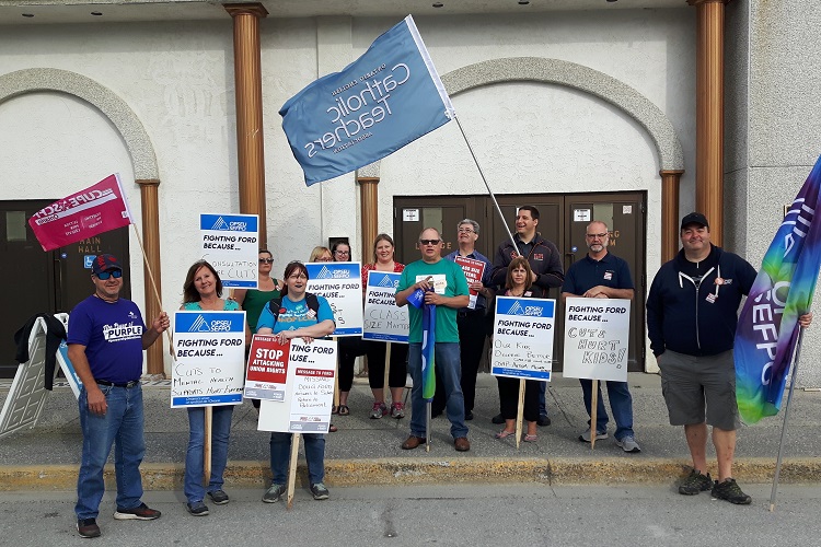 Union members picket outside economic development minister’s speech