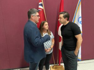 Former provincial Conservative candidate and town of Kap public works general manager Eric Cote speaks with Pierre Poilievre. Photo by Denis J. Puska.