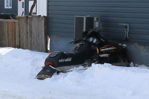 Charges laid in snowmobile-house collision